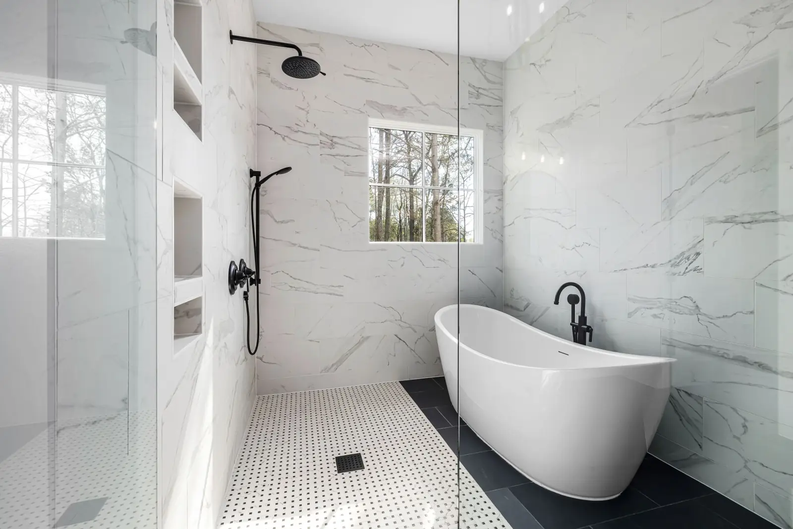 Spotless white marble bathroom with freestanding bath
